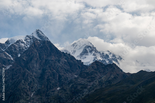 A panoramic view on the snow-capped peaks of Tetnuldi, Gistola, Lakutsia and Jangi-Tau(Dzhangi-Tau) in the Greater Caucasus Mountain Range in Georgia, Svaneti Region. Sharp peaks, wanderlust. © Chris