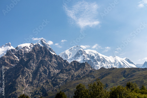 A panoramic view on the snow-capped peaks of Tetnuldi, Gistola, Lakutsia and Jangi-Tau(Dzhangi-Tau) in the Greater Caucasus Mountain Range in Georgia, Svaneti Region. Sharp peaks, wanderlust.