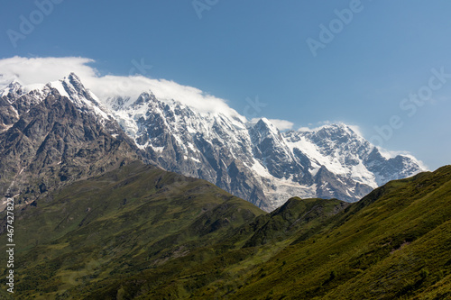A panoramic view on the snow-capped peak of Jangi-Tau(Dzhangi-Tau) in the Greater Caucasus Mountain Range in Georgia, Svaneti Region. Snowy and glaciated terrain. Mountaineering, freedom, wanderlust.