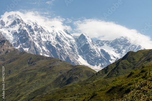 A panoramic view on the snow-capped peak of Jangi-Tau(Dzhangi-Tau) in the Greater Caucasus Mountain Range in Georgia, Svaneti Region. Snowy and glaciated terrain. Mountaineering, freedom, wanderlust. © Chris