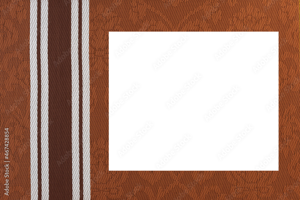 Fototapeta premium Brown fabric background with monogram pattern and a white middle.