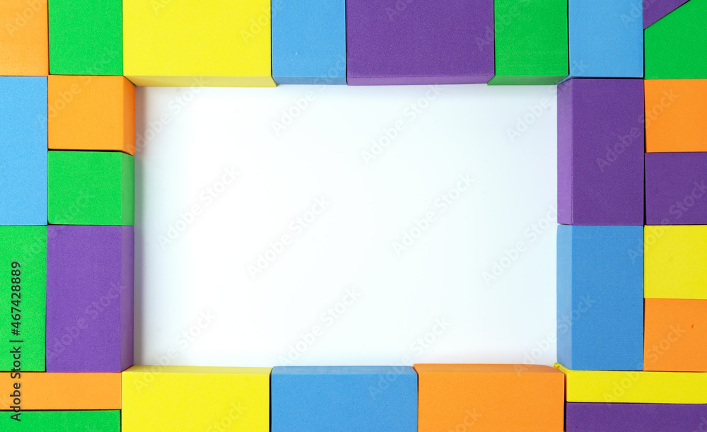 Frame of multi-colored squares, rectangles and triangles with a white middle.