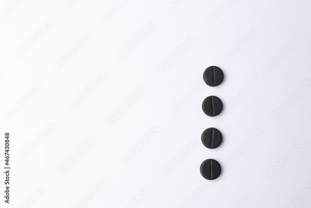 activated charcoal pills black on white background pills health adsorbent activated charcoal pills black on white background pills health adsorbent
