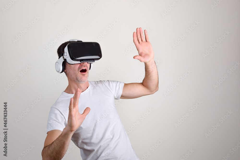 Surprised man using vr glasses white isolated background Surprised man using vr glasses white isolated background