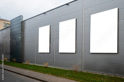 three blank white billboard for advertisement on the facade of building, outdoor advertising concept