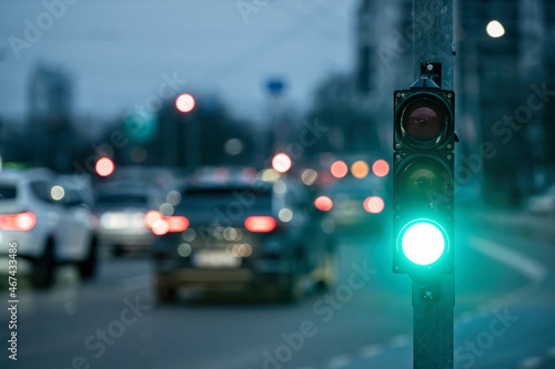 traffic light on the street junction with beautiful bokeh, city with cars in the background