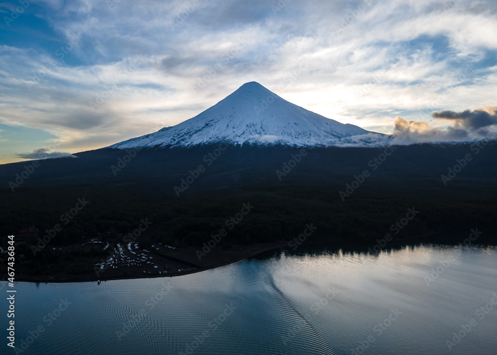 General aerial view of the osorno volcano against the light with the lake of todos los santos and the sunset. General aerial view of the osorno volcano against the light with the lake of todos los santos and the sunset.