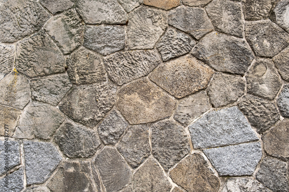 Gray stones cobblestones retro aged wall castle exterior near river in europe Gray stones cobblestones retro aged wall castle exterior near river in europe