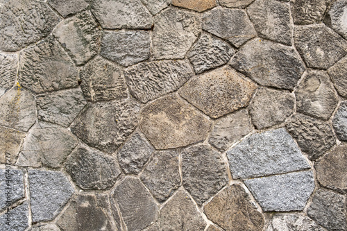 Gray stones cobblestones retro aged wall castle exterior near river in europe