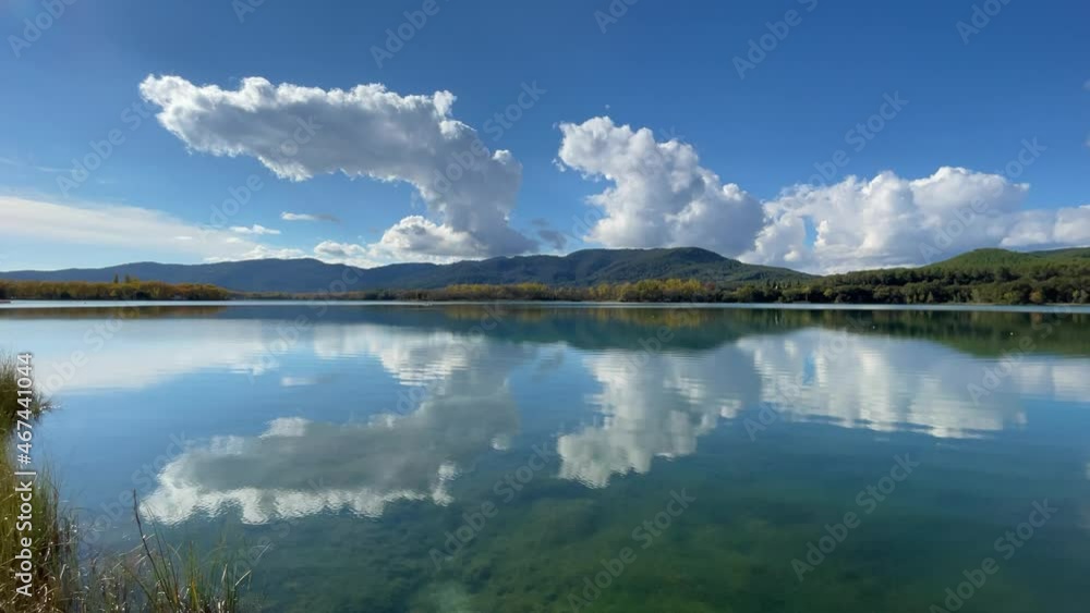 girona lake in banyoles reflects the sky with white clouds calm turquoise water girona lake in banyoles reflects the sky with white clouds calm turquoise water