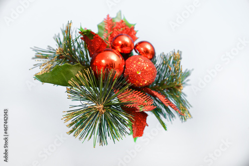 Christmas toys on a pine branch on a gray background. Blank for postcards for Christmas and New Year.