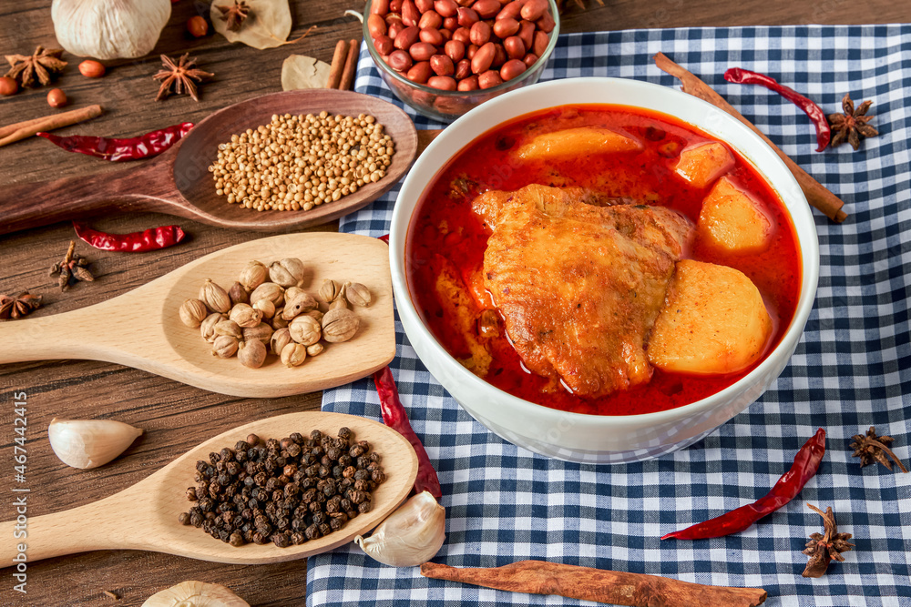 Chicken Massaman Curry on white bowl. Muslim curry or mussaman curry. Muslim style chicken and potato or chicken mussaman curry. Chicken Massaman Curry on white bowl. Muslim curry or mussaman curry. Muslim style chicken and potato or chicken mussaman curry.