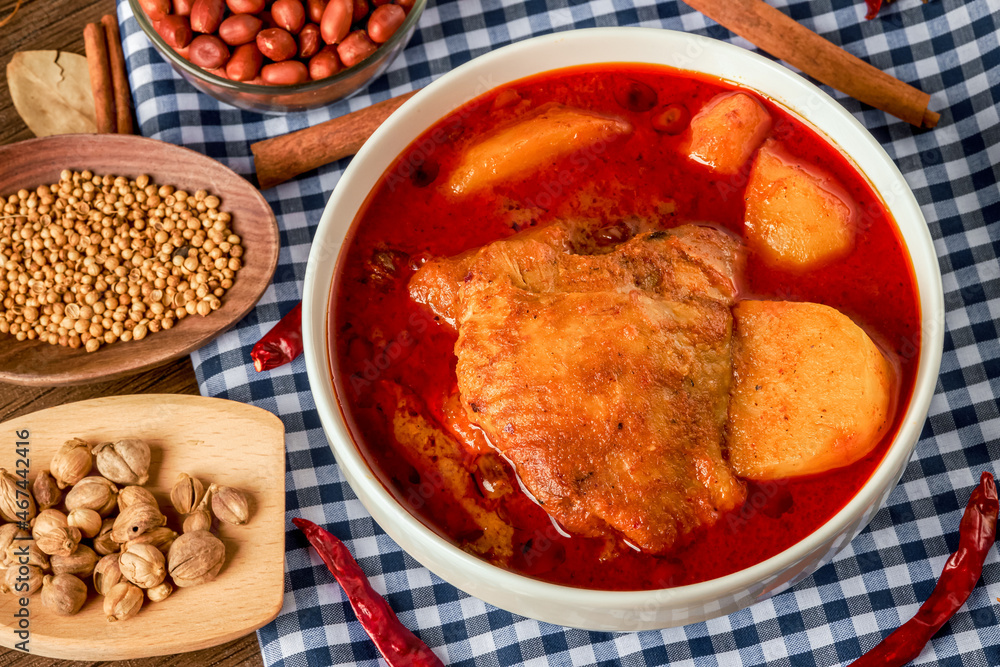 Chicken Massaman Curry on white bowl. Muslim curry or mussaman curry. Muslim style chicken and potato or chicken mussaman curry. Chicken Massaman Curry on white bowl. Muslim curry or mussaman curry. Muslim style chicken and potato or chicken mussaman curry.