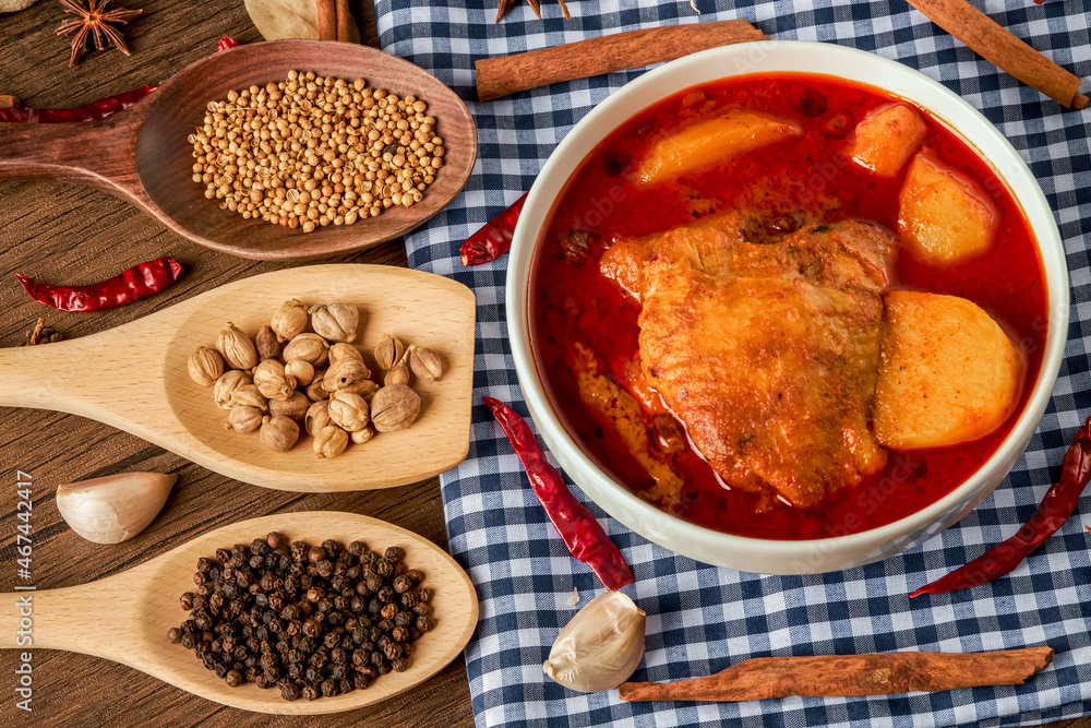 Chicken Massaman Curry on white bowl. Muslim curry or mussaman curry.  Muslim style chicken and potato or chicken mussaman curry.