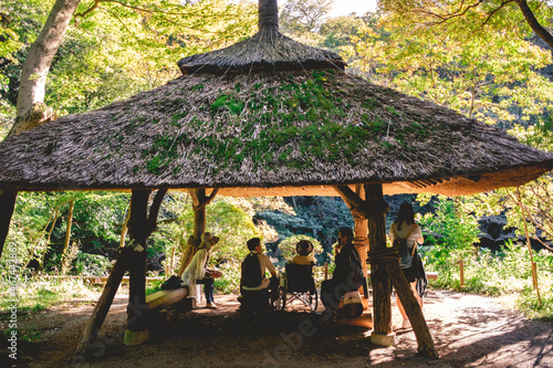 Photography Pavilion with family (grandma in wheelchair) in front of a pond at Meiji Jingu i