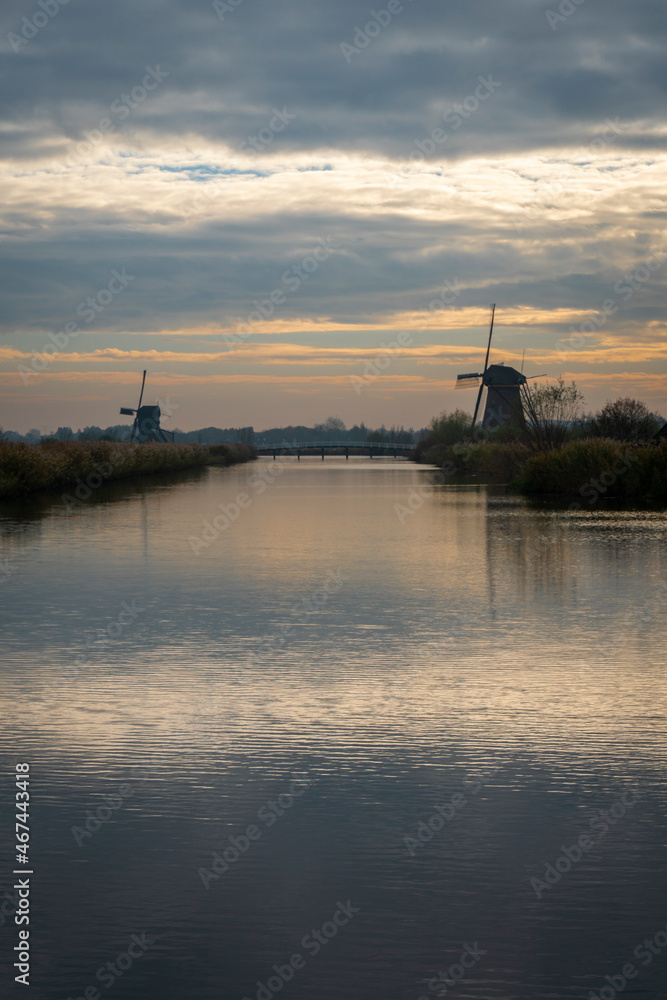 River and windmills at Kinderdijk in Holland at sunset