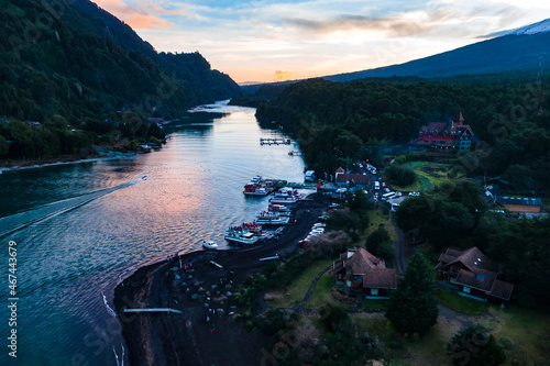 Aerial view of the dock of Todos los Santos lake with boats on the shore at sunset.
