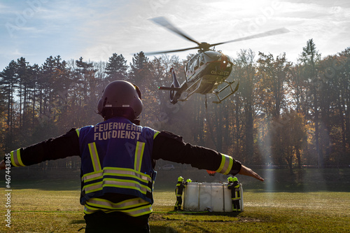 A Fire Department Marshaller is Marshalling signal for Helicopter during a forest fire in Hirschwang, Lower Austria