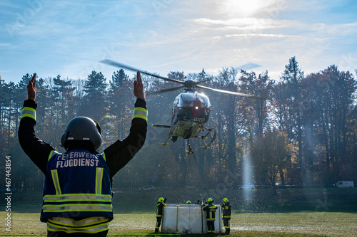 A Fire Department Marshaller is Marshalling signal for Helicopter during a forest fire in Hirschwang, Lower Austria