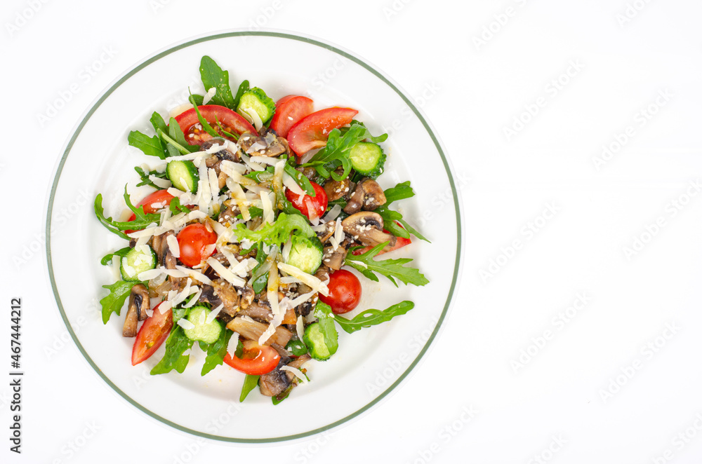 Plate with vegetarian dish of arugula, tomatoes and mushrooms on white background. Studio Photo Plate with vegetarian dish of arugula, tomatoes and mushrooms on white background. Studio Photo