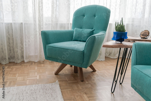 Turquoise blue armchairs on parquet floor in the living room
