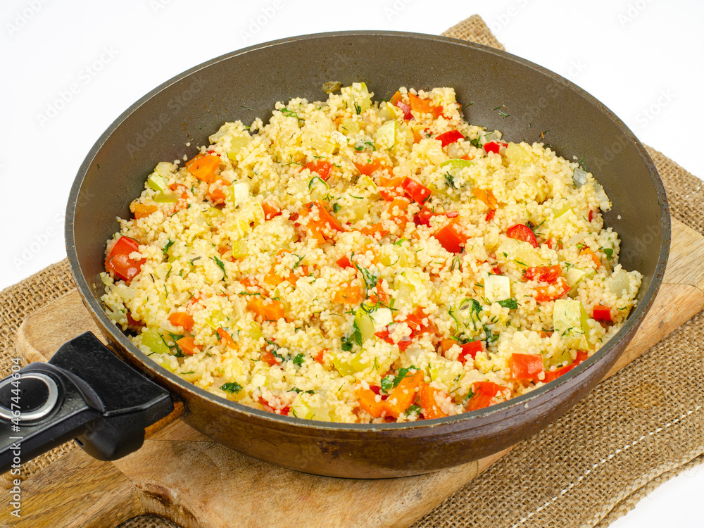 Couscous with vegetables in frying pan. Moroccan cuisine dish. Studio Photo Couscous with vegetables in frying pan. Moroccan cuisine dish. Studio Photo