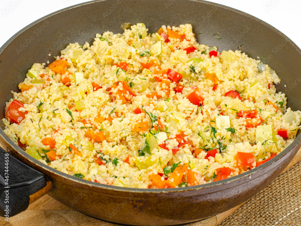 Couscous with vegetables in frying pan. Moroccan cuisine dish. Studio Photo Couscous with vegetables in frying pan. Moroccan cuisine dish. Studio Photo