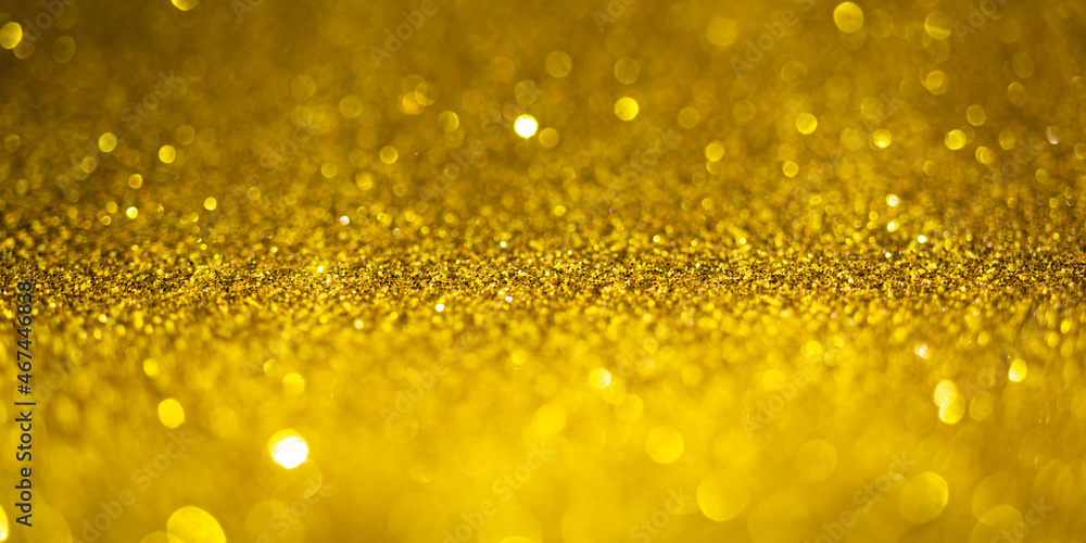 Gold glitter lights. Shiny sparkles, bokeh effects, glowing surface. Selective focus, christmas abstract banner, background Gold glitter lights. Shiny sparkles, bokeh effects, glowing surface. Selective focus, christmas abstract banner, background