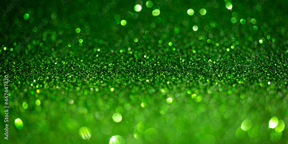 Dark green glitter lights. Shiny sparkles, bokeh effects, glowing surface. Selective focus, christmas abstract banner, background