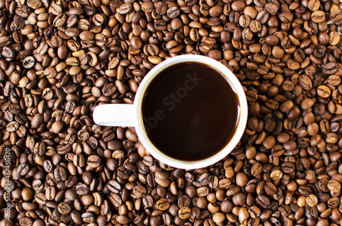 cup of aromatic coffee on a white background and scattered coffee grains. good morning . kind of sveru. flat lay. place for text. coffee time. 