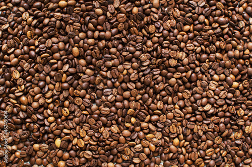 roasted aromatic coffee beans on a dark background. coffee background. flat lay with place for text. view from above. 