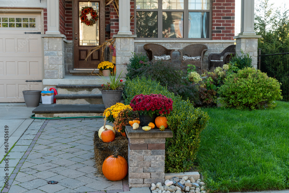 Fragment of the entrance to the house with pumpkins in the foreground