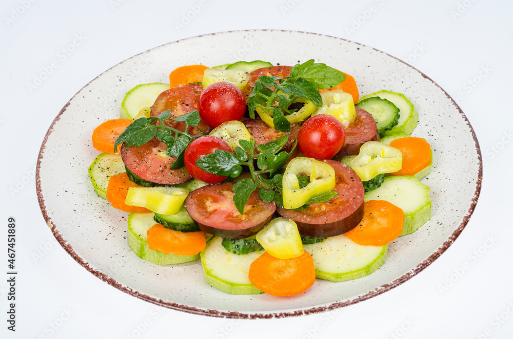Plate with vegetables isolated on white background. Vegetarian food. Studio Photo Plate with vegetables isolated on white background. Vegetarian food. Studio Photo