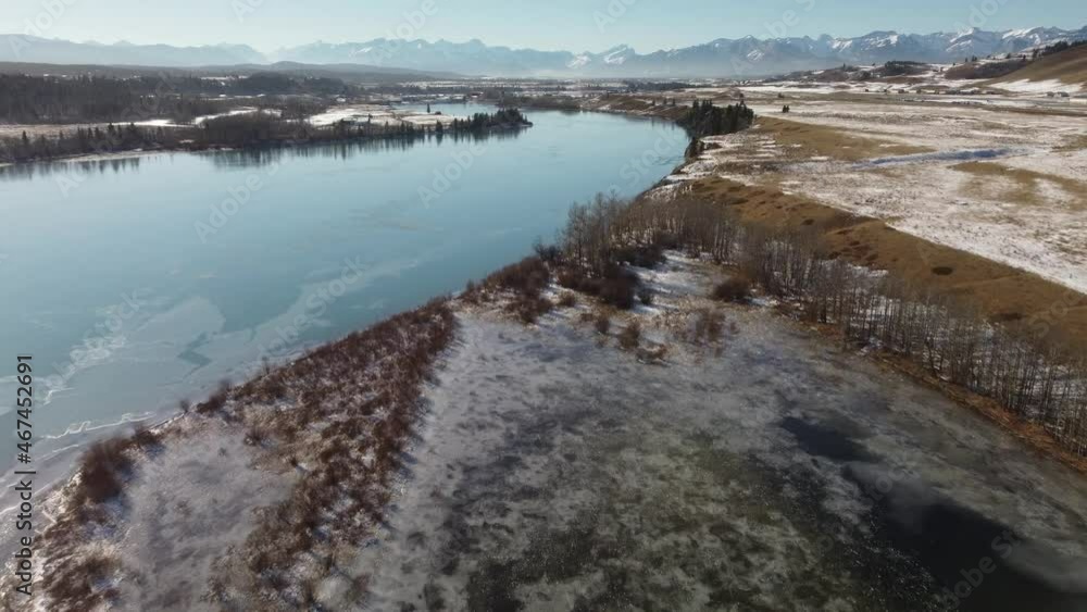Aerial view of frozen Ghost Lake and Rocky Mountains North America. Aerial view of frozen Ghost Lake and Rocky Mountains North America.