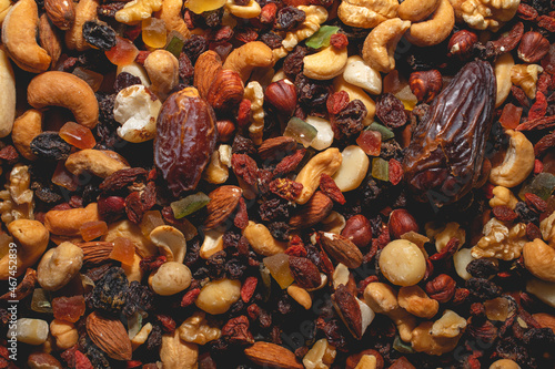 Fototapeta Naklejka Na Ścianę i Meble -  Top view of assorted nuts and dry fruits, including dates, hazel nuts, goji berries, macadamia nuts, almonds and dry fruits.
