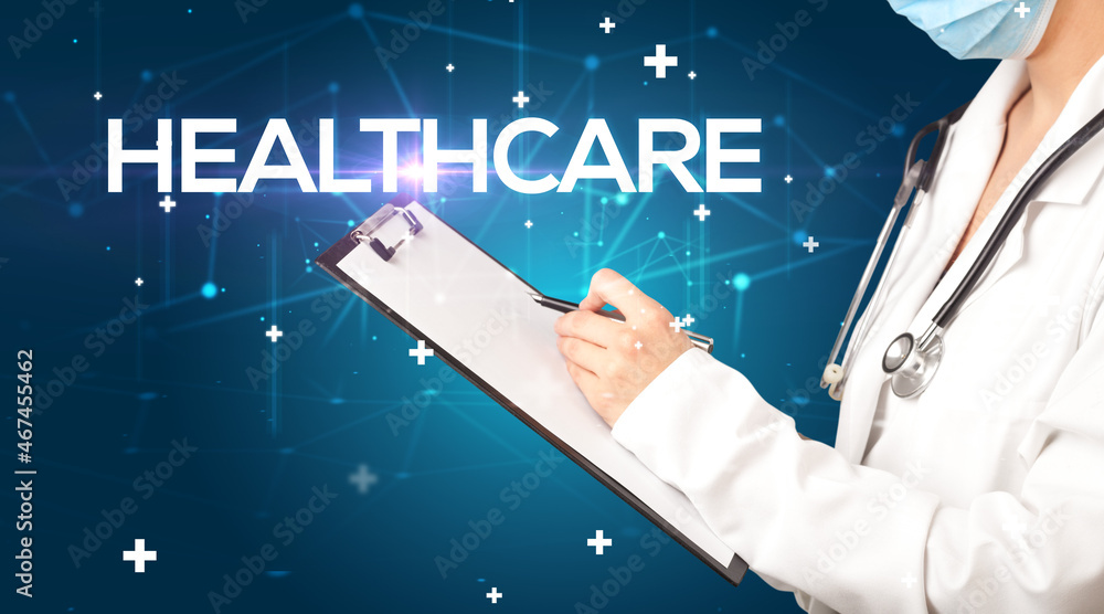 Doctor fills out medical record Doctor fills out medical record