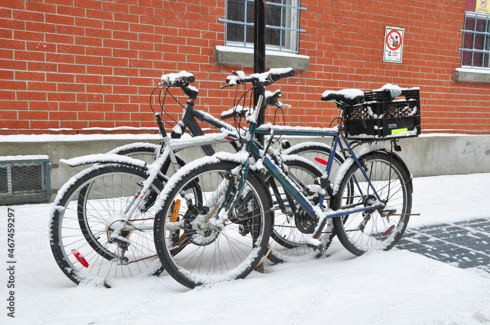 snowing heavy on some bicycles