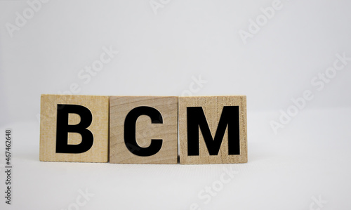 BCM, plan do study act symbol. Businessman hand. Wooden cubes and blocks with words 'PDSA, plan do study act'.