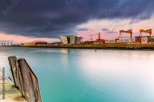 Sunset over Titanic Belfast - museum, touristic attraction and monument to Belfast's maritime heritage on the site of the former Harland and Wolff  two iconic yellow Goliath