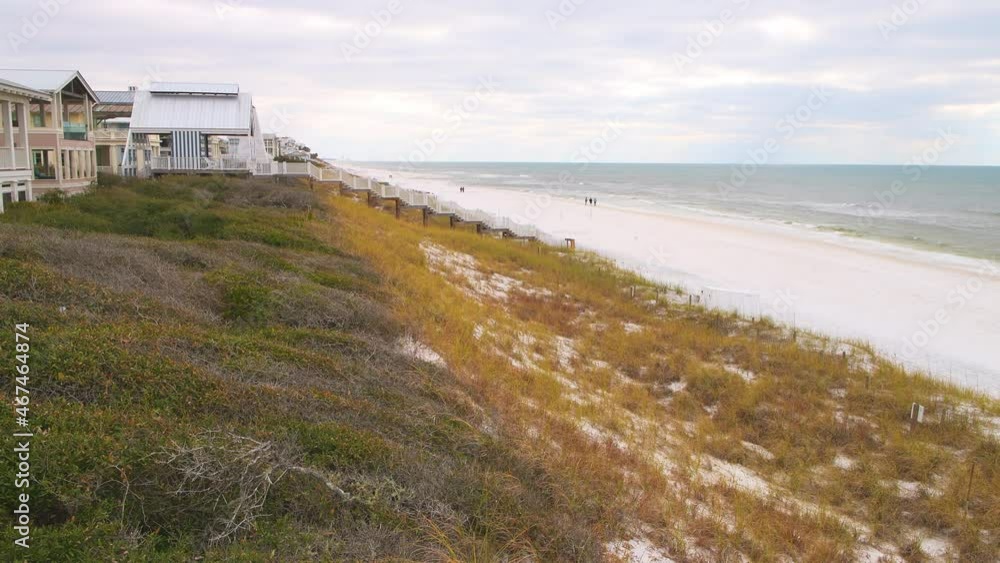 People walking on shore by wooden boardwalk stairs steps from