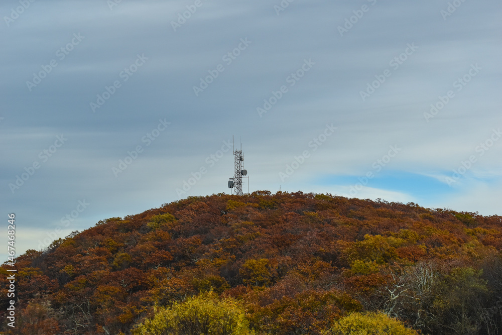 A Communications Tower Sits Atop a Mountain Covered with Beautiful Fall Foliage