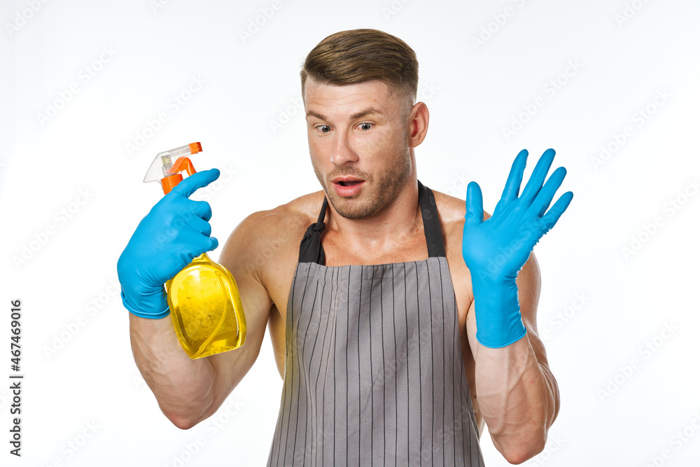 man in apron detergent cleaning service light background man in apron detergent cleaning service light background