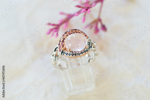 Rose quartz silver ring on the carpet