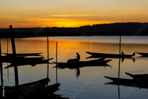  Silhouette at sunset of a fisherman in his boat on the grandiose Paraguacu river photo