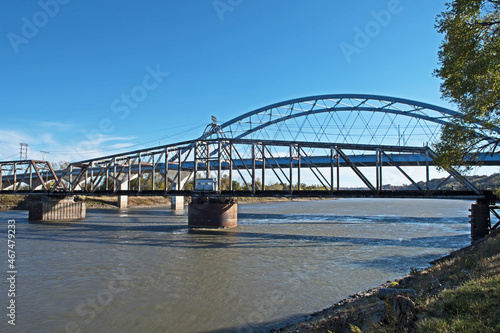 The beautiful Through Truss swing railroad bridge in the foreground and the Amelia Earhart Memorial Bridge  in the background crossing the Missouri River at Atchison, Kansas. photo