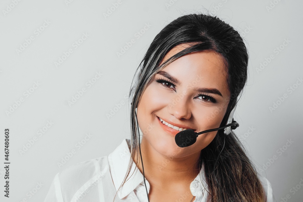 Closeup portrait of agent young hispanic woman using earphones for call center. Closeup portrait of agent young hispanic woman using earphones for call center.