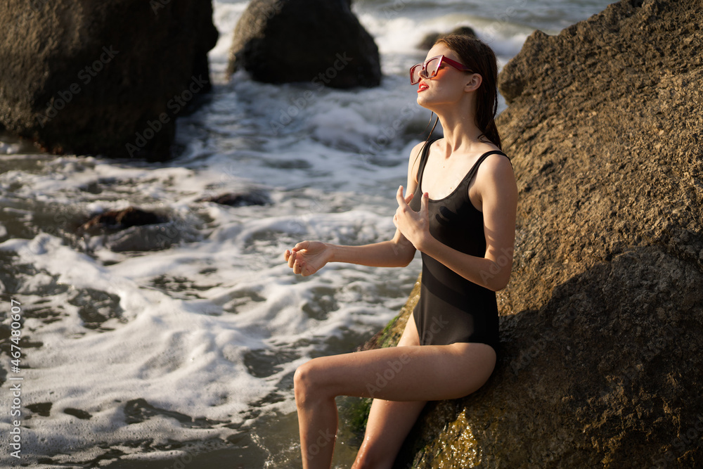 woman in black swimsuit rocks posing oceans woman in black swimsuit rocks posing oceans