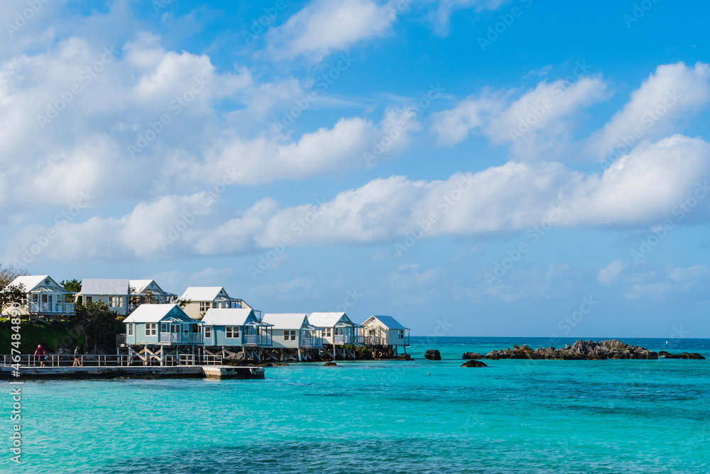 Bermuda's Coastal Symphony: Where azure waters meet vibrant skies, lush landscapes cradle charming houses, creating a harmonious island masterpiece.	