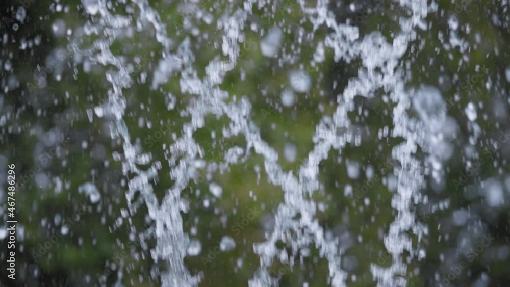 Slow motion of water splashes in the air. Green background. Slow motion of water splashes in the air. Green background.