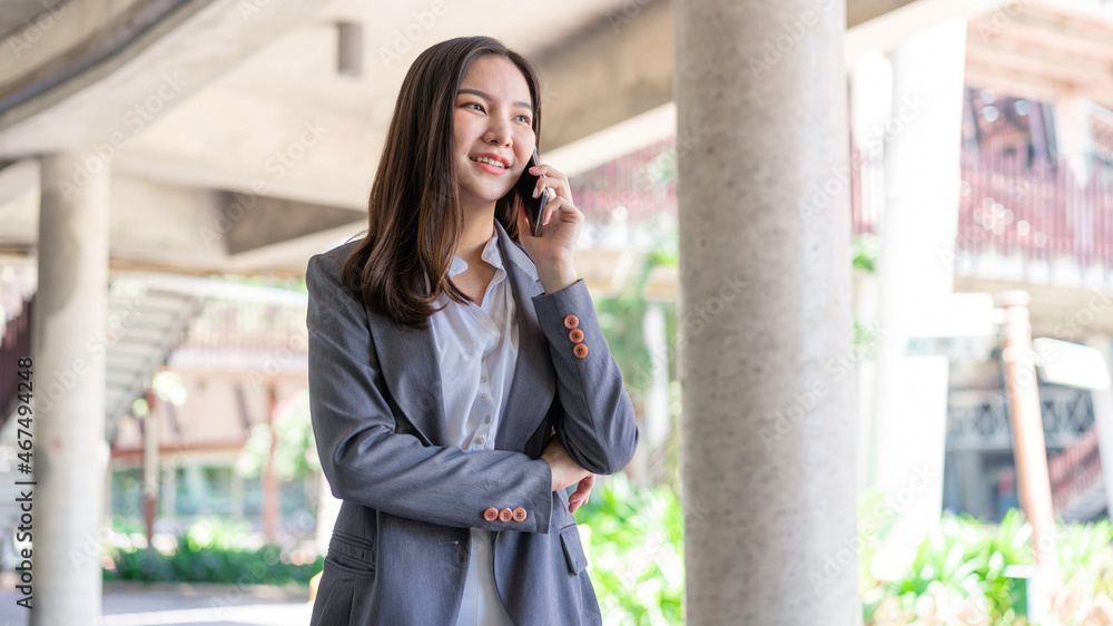 Working woman concept a working woman with smiley face speaking on the phone with her business partner Working woman concept a working woman with smiley face speaking on the phone with her business partner